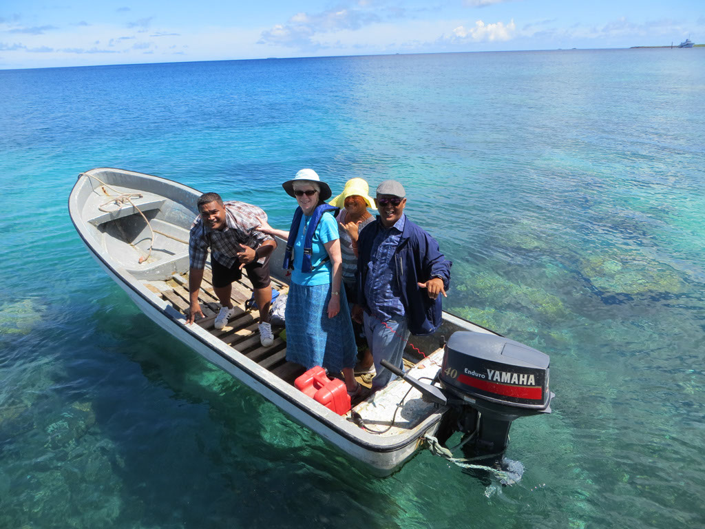 Photo of service providers in a small boat with outboard motor.