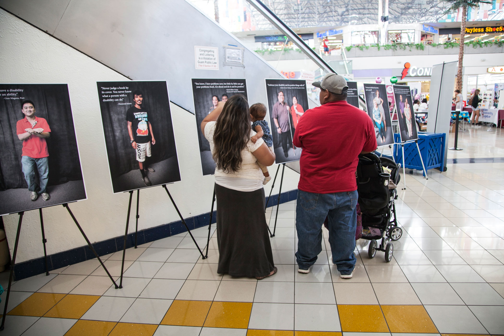 Photo of a family looking at posters at the GSAT AT Fair.
