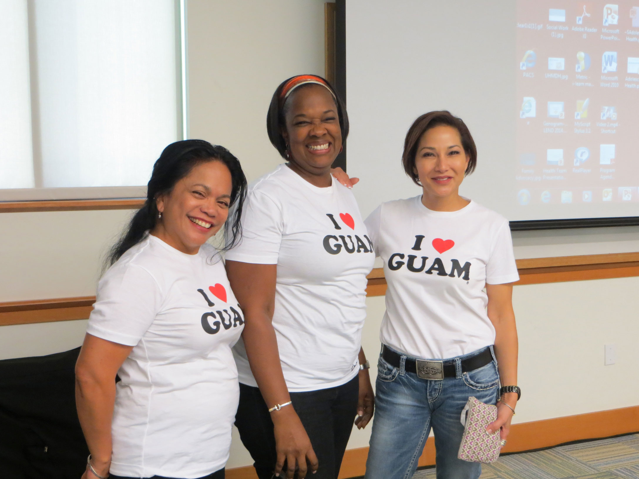 Photo of LEND Trainees conducting a presentation while wearing "I Love Guam" t-shirts.