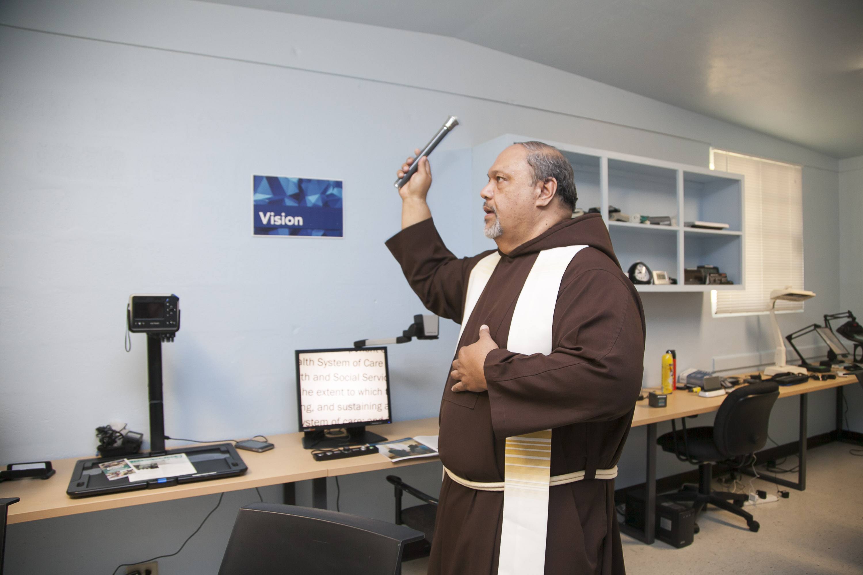 Reverend Father Joseph English, OFM Cap. blesses the newly renovated AT Demo Center.