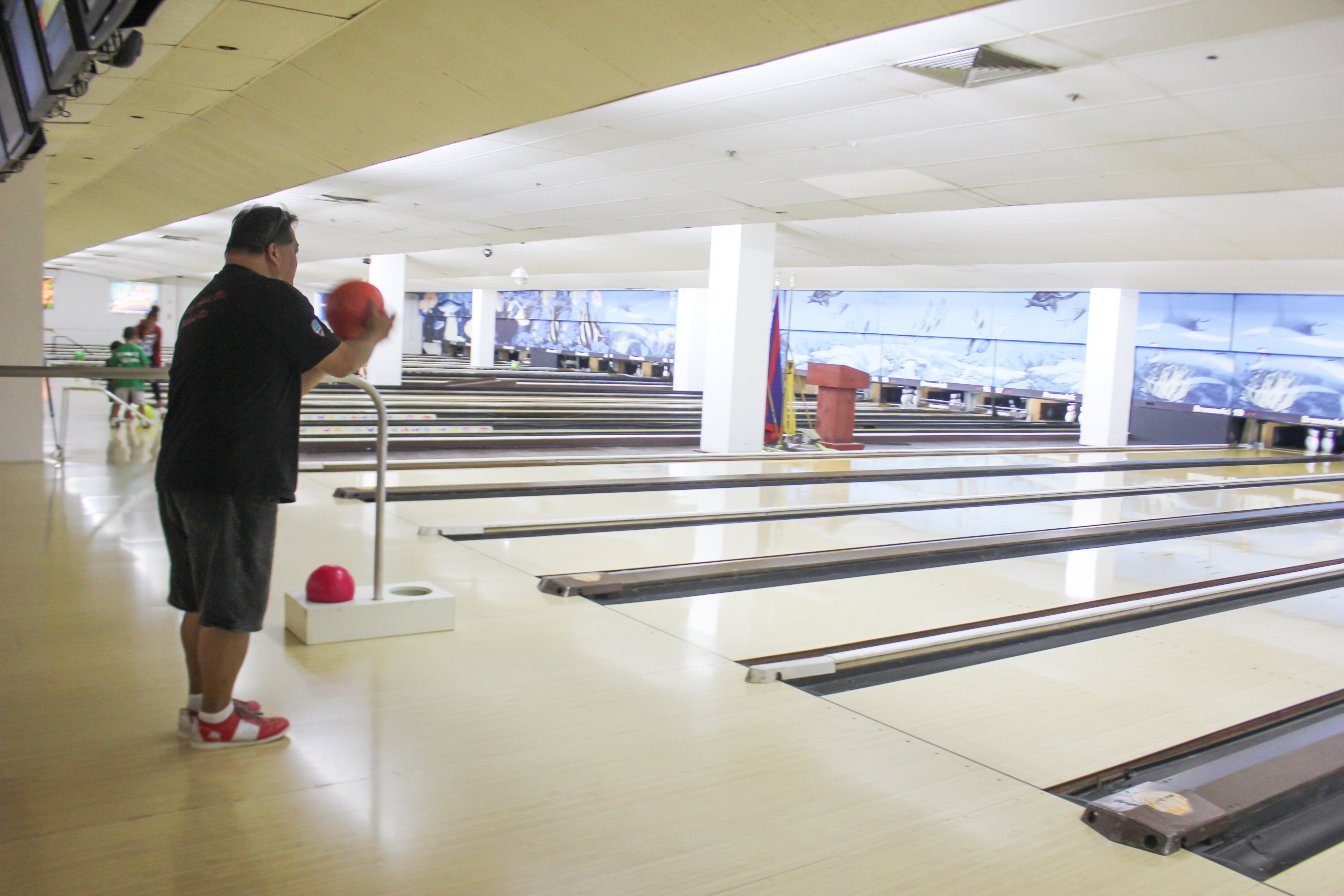 Andrew Tydingco (left), SiñA representative, focuses on a strike during the Bowling Bash.