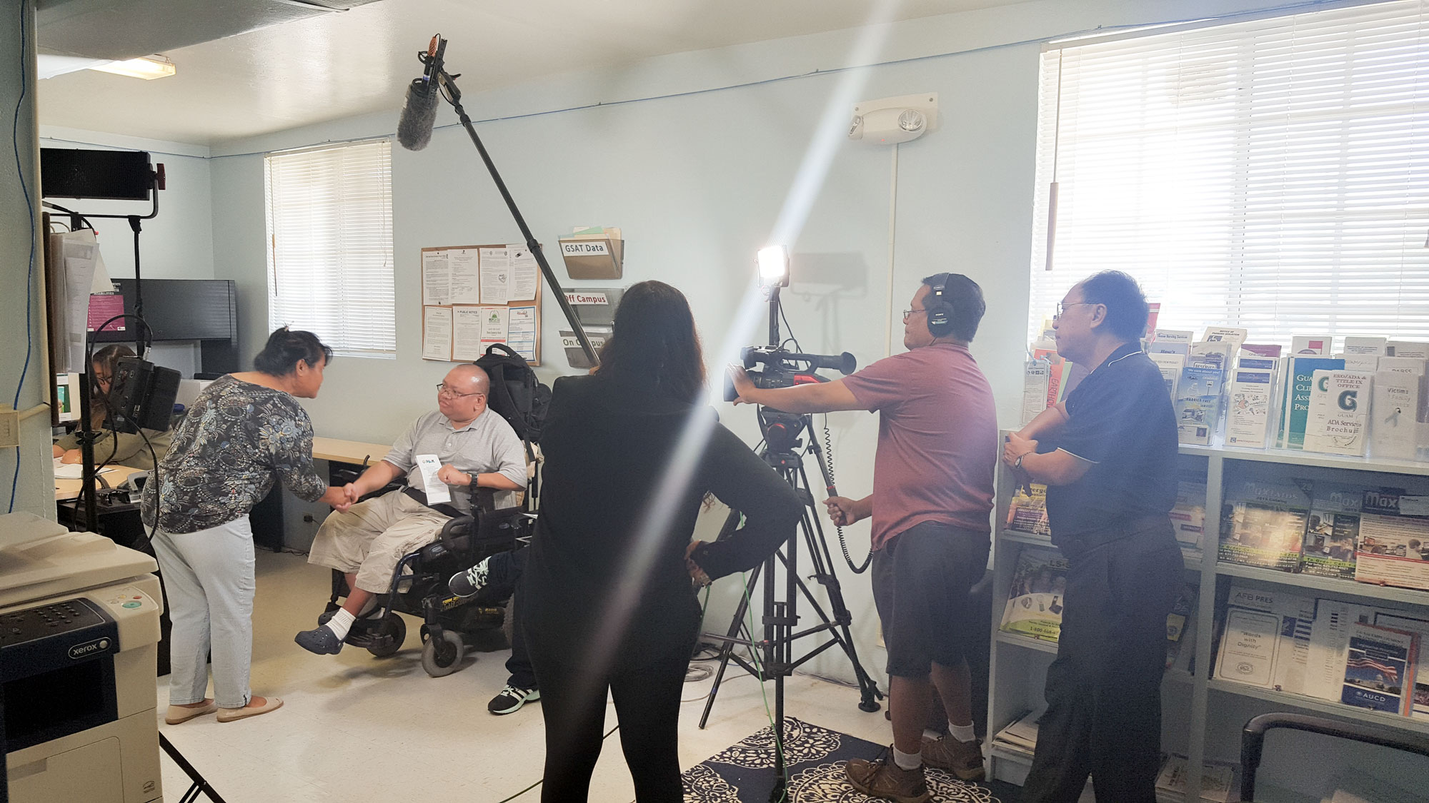 Bernadette Shisler, Guam CEDDERS, shakes the hand of Marlon Molinos, Self-Advocate, during the filming of Ta Fan Acomprendi Tip 5 on July 1. 