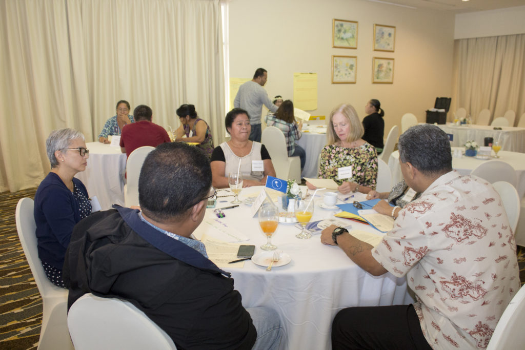 Bonnie Brandt, Guam CEDDERS Training Associate, explains procedures during a table activity with Chuukese Cultural Representatives during the Guam LAUNCH Cultural Conversations Café held on July 14, 2016 at the Guam Hilton Resort & Spa.