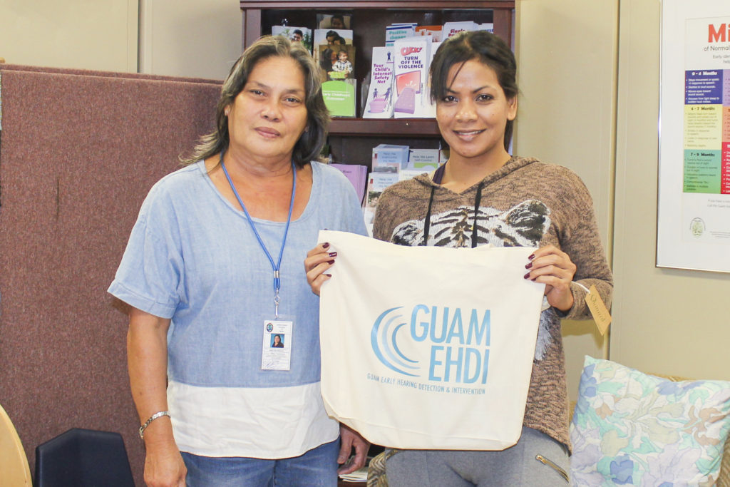 On August 8, Ruth Leon Guerrero, Guam CEDDERS staff (left), delivered 15 Guam EHDI "DAE Toolkits" to Guam Early Intervention System (GEIS). The Toolkits contain resources and information for families who have a child being referred for a Diagnostic Audiological Evaluation (DAE).  Receiving the Toolkits is R-Leen Mario, GEIS staff (right).